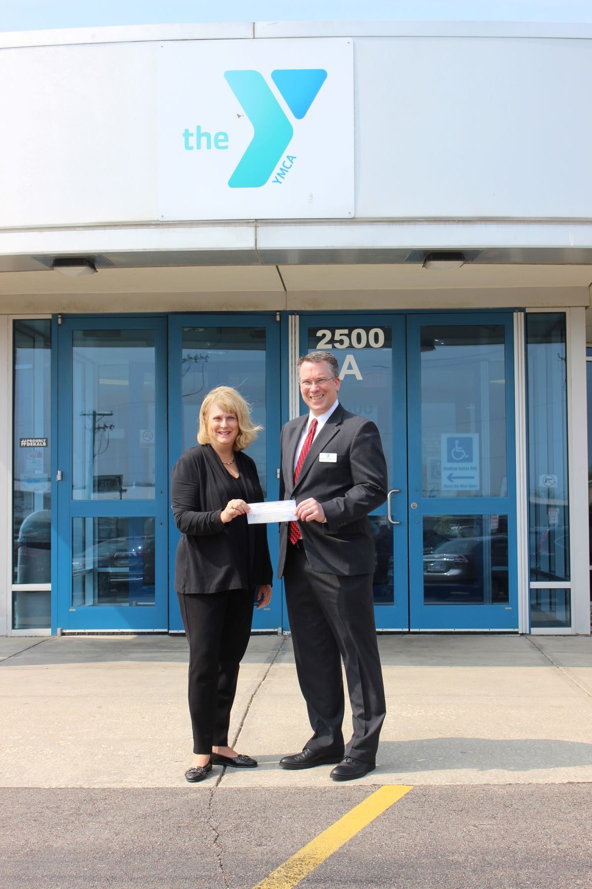 Christine Johnson (DCCF) presents Mark Spiegelhoff (YMCA) with check for portable basketball hoops